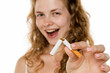 © vladimirfloyd - Young woman breaking cigarette in half, smiling confidently. Symbolizing quitting smoking, health awareness, and personal triumph over addiction