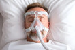 © utaem2022 - Mature man sleeping with cpap machine for sleep apnea treatment
