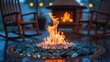 © NeuralNiche - Gas flames dance in an outdoor fire pit lined with glass pebbles. Rocking chairs around an outside fireplace wet from rain.