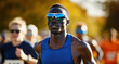 © Denis Renkas - Focused male athlete running in marathon with crowd in background.