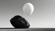 © Ganda - A dark rock sits on a surface, with a white balloon floating above it, connected by a string.