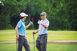 © DJ Creative Studio - Golf Game Between Father and Son Bonding on Green Course With Smile and Connection in Natural Outdoor Setting