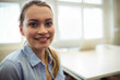 © Wavebreak Media - Woman wearing light blue shirt sitting at office desk with closed laptop near window, copy space
