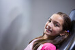 © Wavebreak Media - Girl reclining, smiling in dental chair at clinic with braces and colorful elastics copy space