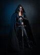 © faestock - portrait of mysterious hooded woman in black cloak, gothic fantasy or dystopian character, holding sword weapon. lit with moody cinematic shadows, studio scene on dark isolated background