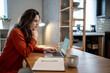 © Migma_Agency - Focused entrepreneur working remotely from home office using laptop