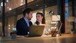 © stockbusters - Creative startupers discussing strategy sitting modern office late evening.