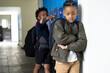 © Wavebreak Media - In school hallway, boy feeling sad while another boy teasing him