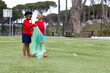 © Wavebreak Media - Diverse boys cleaning park, picking up plastic bottles, enjoying teamwork and nature