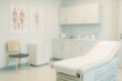 © ArtStockVault - Blurred medical examination room with an examination table and anatomical charts on the wall. Healthcare facility.