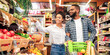 © Prostock-studio - Black Family On Grocery Shopping In Supermarket. Happy African Couple Buying Organic Vegetabels And Fresh Fruits In Local Food Store Standing With Shop Cart. Customers Choosing Supplies
