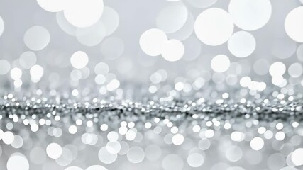 Sparkling silver glitter background with bokeh lights creating a festive and elegant abstract pattern