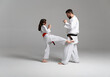 © oscar - Father and daughter practicing kyokushinkai karate kicks together