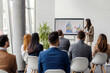 © Dusan Petkovic - Young female analyst is standing near interactive board and showing charts and statistics to audience.