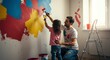 © @KaeDA - Father and daughter painting wall together indoors