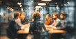 © hao - blurred photo of business people sitting around the table in an office, captured from behind and in focus, symbolizing collaboration within  company or between different quaint style icons.