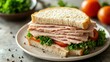 © mlangsen - Ham sandwich with tomatoes & lettuce on a neutral plate
