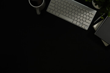Wall Mural - flat lay of modern dark desk with keyboard, notebook, pen, and coffee mug.