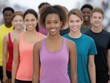© alsu0112 - Group of diverse young adults in colorful athletic wear standing together, showcasing unity and motivation in a fitness environment, embodying the spirit of running and teamwork