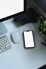 Wall Mural - top view of smartphone with blank screen on modern white desk workspace