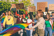 © Carlo Prearo - Activists marching for lgbtq+ rights and women's rights holding signs and rainbow flag