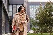 © Bliss - University teacher walking outside, showcasing knowledge and confidence amidst modern architecture