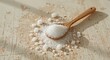 © muhammadarslan - A wooden spoon holding a pile of salt crystals on a distressed surface in bright natural light