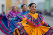 © digitalpochi - Hispanic woman is smiling while wearing a colorful dress during a hispanic heritage month parade