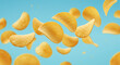 © MuhammadHassan - A dynamic shot of golden potato chips suspended against a vibrant light blue background showcasing snack food