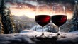 © Raul - Two wine glasses are sitting filled with red wine on a snowy surface with a winter landscape background.