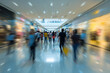 © lashkhidzetim - A blurry image of a crowded mall with people walking and shopping. Scene is busy and bustling, with people moving quickly and carrying bags