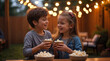 © Yosich1961 - Young boy and girl smiling while sharing popcorn at outdoor party