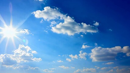 Wall Mural - bright blue sky filled with fluffy clouds and radiant sun, creating cheerful and serene weather