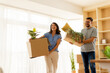 © BGStock72 - Two friends joyfully moving into their new apartment filled with light and greenery on a bright sunny day