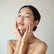 © miss irine - Asian woman portrait showing smooth clear skin. Beauty model with elegant, natural expression. Ideal for skincare, cosmetics, dermatology content. Facial, skin care concept.