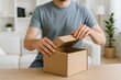 © Jafree - Man unboxing delivery package at home, experiencing surprise and excitement. concept of online shopping, home delivery, anticipation