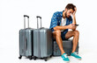© Pete - Shocked man sits suitcase looking smartphone. Tourist got travel problems. Flight delay, cancellation. Frustrated guy with baggage waits in airport or train station. Travel stress concept.