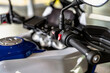 © andov - Motorcycle controls showcase detailed design and functionality at a garage setting during daytime maintenance session