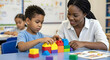 © Autism in Focus - Autism, ADHD, Neurodiversity, Child, Therapy. Therapist supports focused boy building colorful block bridge during inclusive therapy session