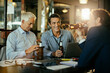 © Marko Geber - Diverse group of male businessman having a beer and celebrating closing a deal on their job