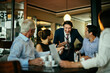© Marko Geber - Group of business people having a meeting in a cafe bar