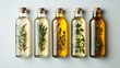© Akifah - Four glass bottles of infused oils, each with a different herb