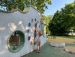 © Anna Zhosanova - Colorful playground clock wall with a child playing. Educational design for public play areas encouraging interactive learning and exploration.