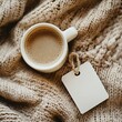 © Dariya - Overhead View of Coffee Cup on Beige Knit Sweater with Blank Tag