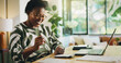 © peopleimages.com - Happy, black woman and finance with laptop for payroll, tax return or budget planning at home. Female person, accounting or smile with calculator, documents or bills for expenses, deductions or audit