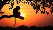 © Edwin - Silhouette of a monkey on a branch at sunset.