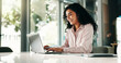 © peopleimages.com - Finance, laptop and typing with business woman in office for review of account, information or report. Computer, investment and smile with financial analyst at desk in workplace for wealth management