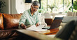 © PP/peopleimages.com - Mature woman, remote work and document for finance, budget review or asset management. Reading, freelancer and person with paper in living room for accounting, insurance or expenses on laptop in home