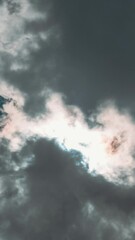Wall Mural - Dark Clouds Give Way To White Fluffy Clouds And Clear Skies. Sunray Shine Through Clouds In Cloudy Blue Sky. Natural Background Sky Time Lapse. Dark Clouds Disperse And Clear Skies Appear. Sun Shines