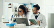 © peopleimages.com - Science, team and people on tablet with microscope for analysis, medical research and lab study. Happy, pharmaceutical and man with woman on digital tech for vaccine results, review and online report